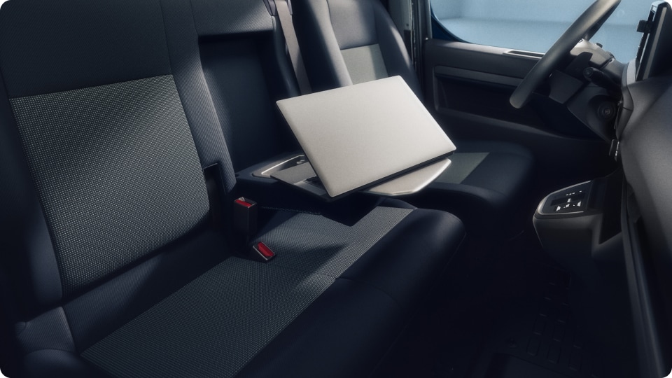 Vivaro’s interior showing a laptop resting on a fold-down seat table